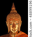 The gold buddha statue face on black background  48899196