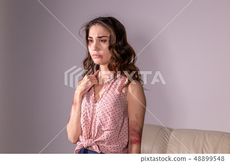 violence issues - Woman victim of domestic violence and abuse over grey background violence issues - Woman victim of domestic violence and abuse over grey background 48899548