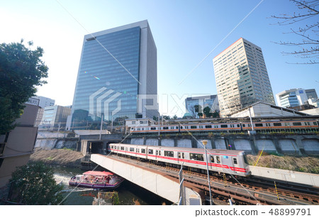 Tokyo cityscape in Japan Sightseeing of sightseeing boat and commuter train of Ochanomizu Station (in front: Tokyo Metro Marunouchi Line running on the ground section) 48899791