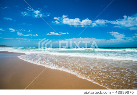 Yellow sand beach, sea and deep blue sky. Yellow sand beach, sea and deep blue sky. 48899870