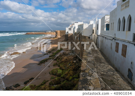 Landmark of Asilah - Atlantic Ocean Surf and Old City Wall with white houses on Seaside. Asilah 48901034