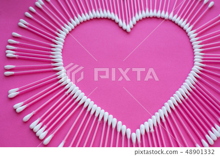 cotton buds laid out in the shape of a heart on a cotton buds laid out in the shape of a heart on a 48901332
