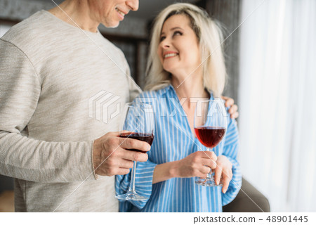 Adult love couple drinks red wine at home 48901445