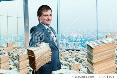 Young businessman holding out a wad of money Young businessman holding out a wad of money 48901593
