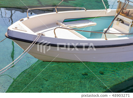 A fishing boat in Pomos harbour and crystal clear A fishing boat in Pomos harbour and crystal clear 48903271
