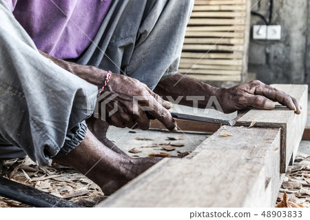 Close up of warn hands of carpenter working in traditional manual carpentry shop in a third world 48903833
