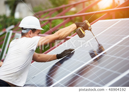 Installation of stand-alone exterior photo voltaic panels system. Renewable green energy generation. Installation of stand-alone exterior photo voltaic panels system. Renewable green energy generation. 48904192