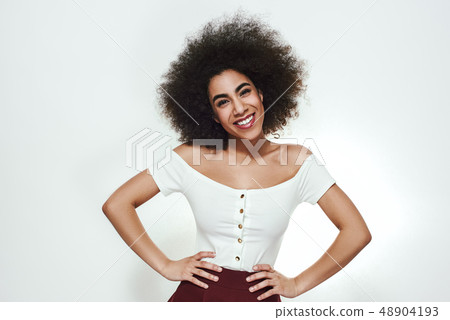 Feeling beautiful. Attractive young african woman with curly hair looking at camera and smiling 48904193