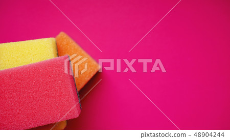 Household cleaning concept. Colorful sponges on pink background Household cleaning concept. Colorful sponges on pink background 48904244