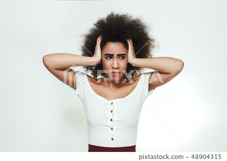 Too much problems in one moment. Sad and frustrated afro american woman is holding head in hands Too much problems in one moment. Sad and frustrated afro american woman is holding head in hands 48904315