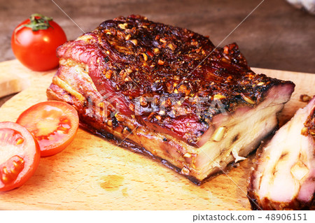 Sliced grilled pork ribs barbecue Striploin steak with chimichurri sauce and tomatoes on cutting Sliced grilled pork ribs barbecue Striploin steak with chimichurri sauce and tomatoes on cutting 48906151