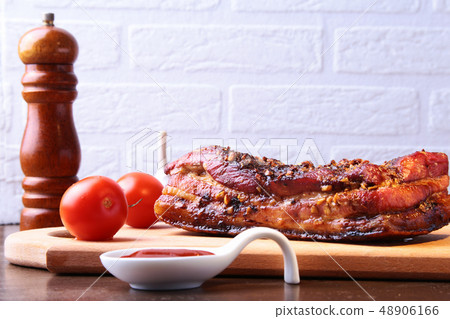 Sliced grilled pork ribs barbecue Striploin steak with chimichurri sauce and tomatoes on cutting Sliced grilled pork ribs barbecue Striploin steak with chimichurri sauce and tomatoes on cutting 48906166
