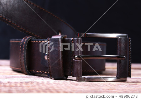 Men elegance leather belt on wooden table. 48906278