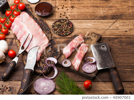 Fresh raw pieces of pork ribs on chopping board Fresh raw pieces of pork ribs on chopping board 48907001
