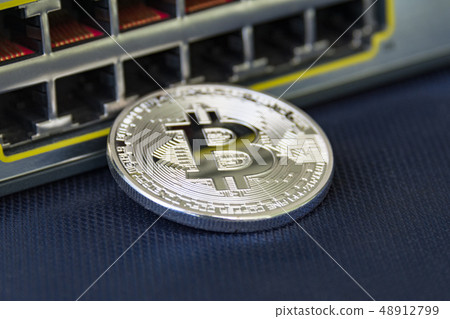 Mint bitcoin with ethernet ports on the background. 48912799