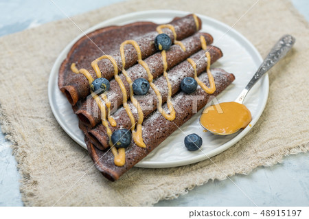 Chocolate crepes with caramel sauce and 48915197