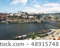 Ancient boats on Douro River. Dom Luis Bridge. 48915748