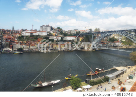 Ancient boats on Douro River. Dom Luis Bridge. Ancient boats on Douro River. Dom Luis Bridge. 48915748