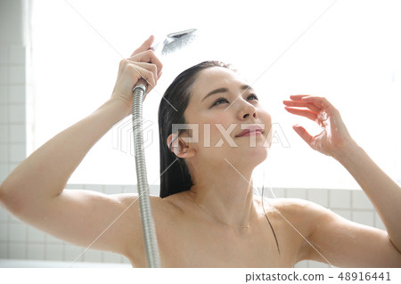 Woman taking a shower Woman taking a shower 48916441