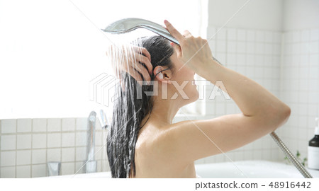 Woman taking a shower Woman taking a shower 48916442