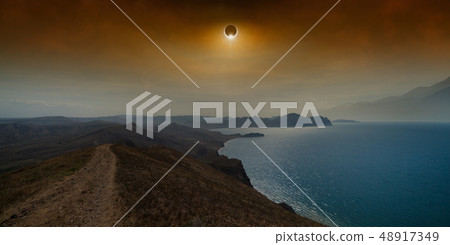 Total solar eclipse in dark red sky above sea and Total solar eclipse in dark red sky above sea and 48917349