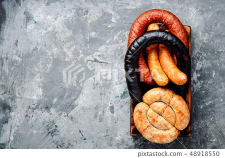 Smoked sausages on cutting board Smoked sausages on cutting board 48918550