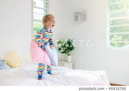 Child playing in bed. Kids room. Baby boy at home. 48918768
