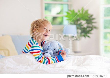 Child playing in bed. Kids room. Baby boy at home. Child playing in bed. Kids room. Baby boy at home. 48918769