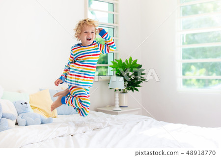 Child playing in bed. Kids room. Baby boy at home. Child playing in bed. Kids room. Baby boy at home. 48918770