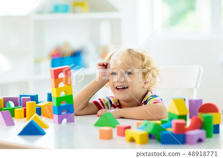Kids toys. Child building tower of toy blocks. 48918771