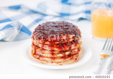 Pancakes with jam on plate on tabl 48920291
