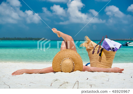 Woman lying down on beach 48920967