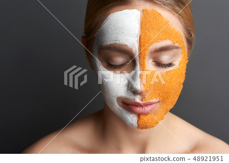 Smiling woman having mask on the face and closing her eyes Smiling woman having mask on the face and closing her eyes 48921951