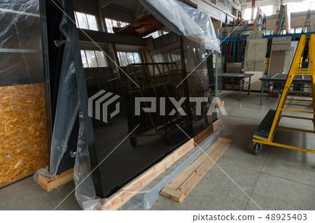 Interior of a large glass and mirror cutting factory Interior of a large glass and mirror cutting factory 48925403