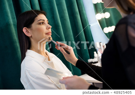 Low angle of beautiful Caucasian woman situating in beauty studio 48925405