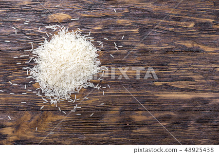 Heap of rice on wooden table, top view. Heap of rice on wooden table, top view. 48925438
