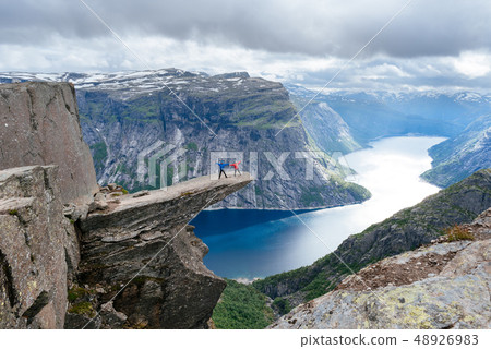 Couple of tourists on Trolltunga in Norway Couple of tourists on Trolltunga in Norway 48926983