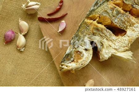 deep fried salty bass fish with garlic and chili  48927161