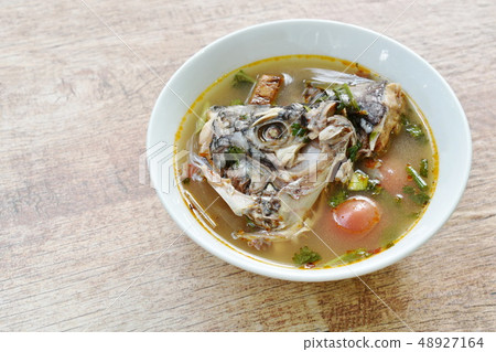 spicy boiled Tilapia head fish in tom yum soup  48927164