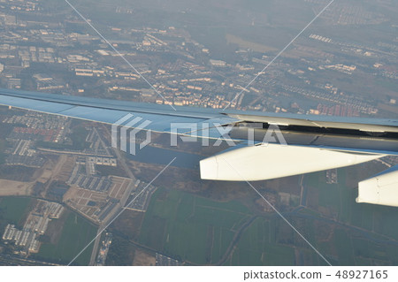 plane wing  through window frame and city view   48927165