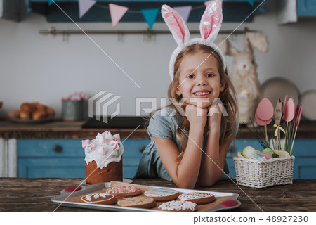 Little happy girl with Easter bakery on kitchen Little happy girl with Easter bakery on kitchen 48927230