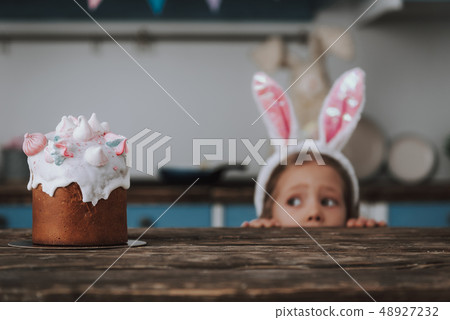 Festive decorated Easter cake on kitchen table 48927232
