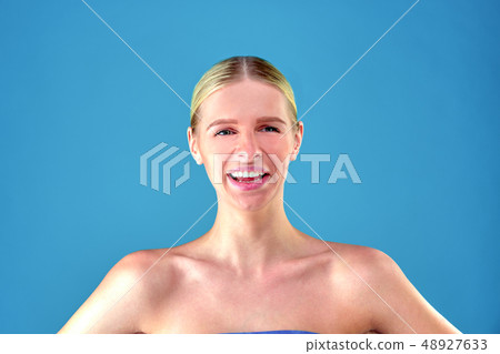 Perfect blonde girl, young blonde girl at blue background. Close up portrait. Skin care concept Perfect blonde girl, young blonde girl at blue background. Close up portrait. Skin care concept 48927633