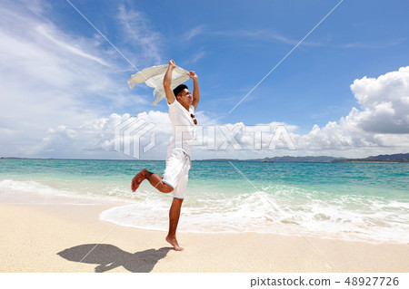 A man playing on a beautiful beach in Tropical country 48927726