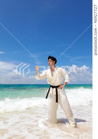 Men training on a beautiful tropical country beach Men training on a beautiful tropical country beach 48927727