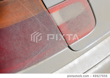 Dirt on the headlights of the car 48927856