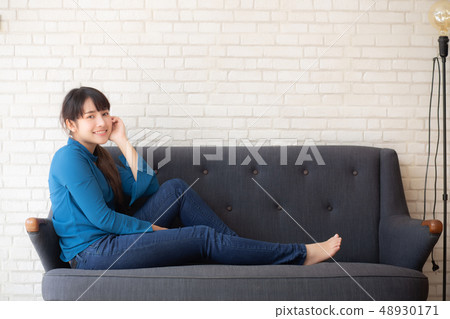 Beautiful portrait asian woman sitting sofa Beautiful portrait asian woman sitting sofa 48930171