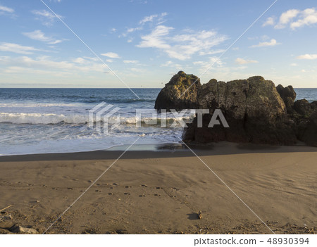 Sand beach of town Vila Franca do Campo with volcanic rocks in ocean, blue sky and white clouds, Sao 48930394