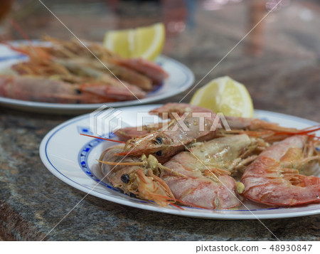 close up boiled giant red prawns with lemon and garlic on plate on marblel desk close up boiled giant red prawns with lemon and garlic on plate on marblel desk 48930847