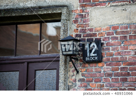 AUSCHWITZ POLAND March 12 2019 Name board and lantern with number 12 at shed block by Concentration AUSCHWITZ POLAND March 12 2019 Name board and lantern with number 12 at shed block by Concentration 48931066